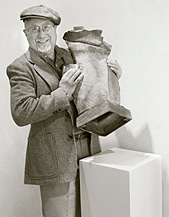Roger Arvid Anderson holding one of his works